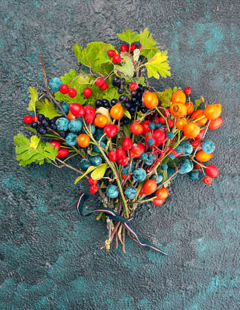 Bouquet of wild berries on a textural background top view with copy spaceの写真素材