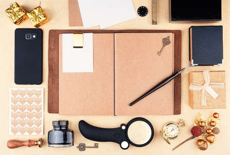 Open working notepad with brown kraft paper with copy space. Template greeting card workspace with...