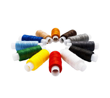 Set of multi-colored cotton threads on plastic spools arranged in a circle isolated. Side viewの写真素材