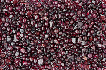 Small rounded garnet stones textured backgroundの写真素材