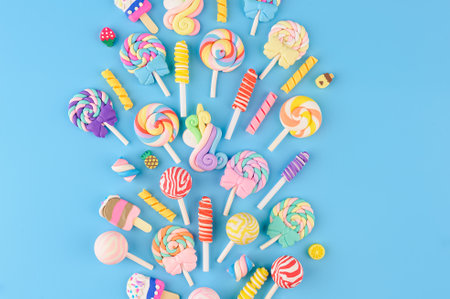 Explosion of decorative candies, lollipops and ice cream. top view on blue backgroundの写真素材