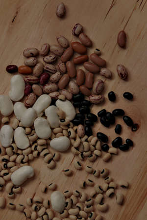Dried beans on wooden board.