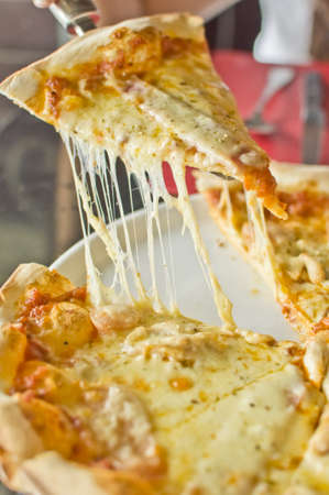 Slice of pizza margarita lifted upの写真素材