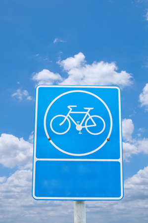 roadsign bicycle under cloudy skyの写真素材