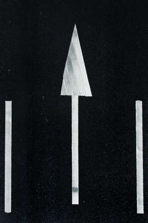 road marking  white arrows and rectangles on the dark asphalt road の写真素材