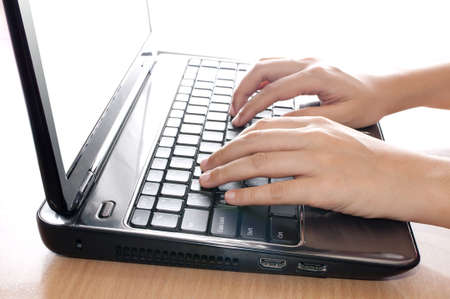 Woman hands working on labtopの写真素材