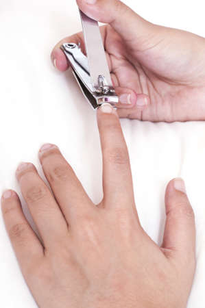 close up of hand doing cutting with nail clipperの写真素材