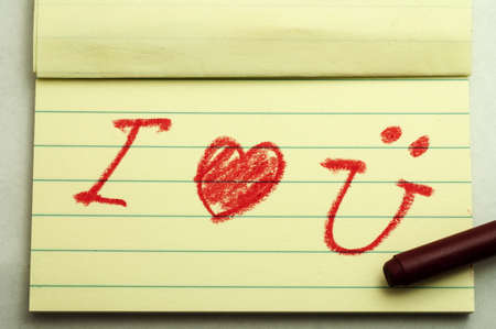 Hand writing love note with crayonの写真素材