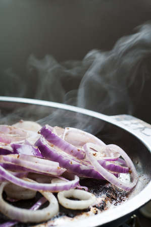 red onion cooking in frying panの写真素材