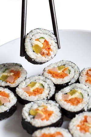 Sushi roll on plate with chopsticksの写真素材