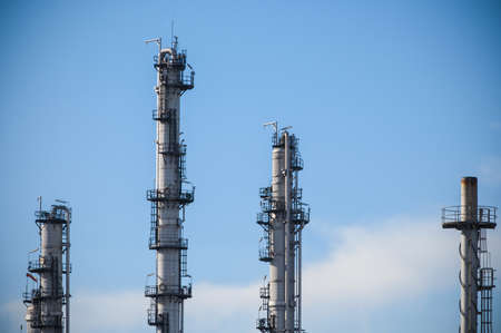 Tower of oil refinery with blue sky background