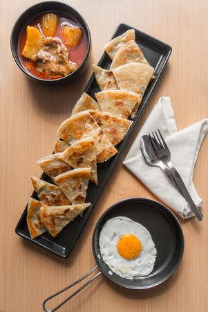 Chicken curry with roti and egg, Indian mealの写真素材