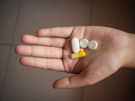Pills in hand.