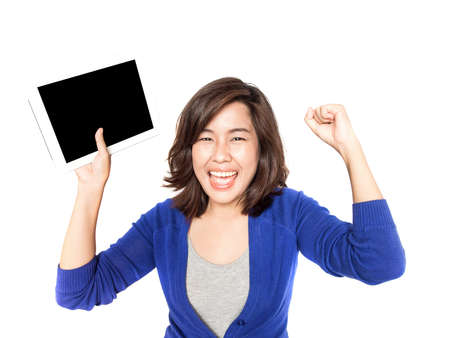 Isolated portrait of beautiful young woman with digital tablet on white background. Pretty female model smiling happy feeling great.の写真素材