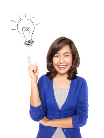 Woman smiling pointing up showing doodle light bulb idea. Closeup of beautiful young professional businesswoman isolated on white background.の写真素材