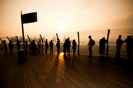 SINGAPORE - MARCH 09:Tourist roaming the Marina Bay Sands observation deck on MARCH 09, 2014 in Singapore. It's the world's most expensive standalone casino property at US$ 6.3 billion.のeditorial素材