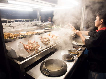 SELANGOR MALAYSIA - 13 NOVEMBER, 2014: Unidentified man sells seafood BBQ and Shabu-Shabu call âLok Lokâ on Kota Kemuning, Shah Alam, Selangor. The food stalls is one of famous local outdoor dinning in Malaysia.のeditorial素材