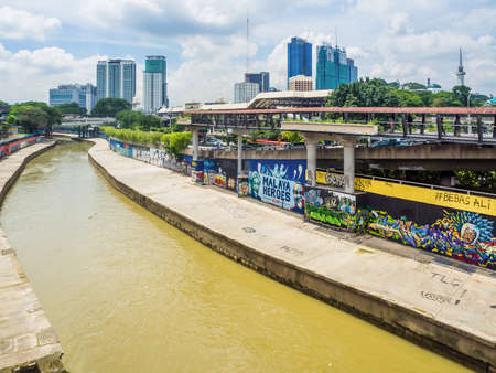 KUALA LUMPUR, MALAYSIA - NOVEMBER 14, 2014 : Urban graffiti along Klang River riverbank near the Pasar Seni LRT station in Kuala Lumpur, Malaysiaのeditorial素材