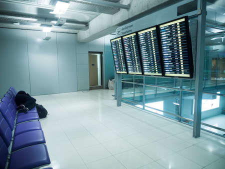 BANGKOK, THAILAND - JANUARY 17, 2015 : Passenger sleeping on chairs in front of departures board at Suvanaphumi Airport.のeditorial素材
