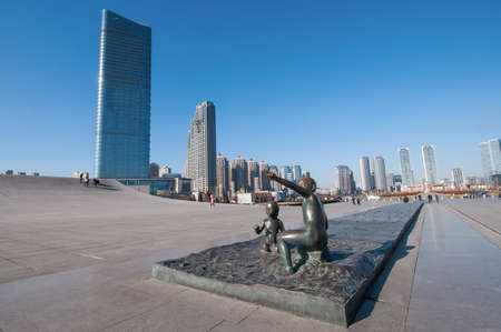 Dalian, China - January 19, 2015 : Dalian, China - January 19, 2015 : Sculpture of boy and girl in front of Xinghai Square . The Square covers total area of 1.1 million square metre, making it the largest city square in the world.のeditorial素材