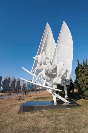 Dalian, China - January 19, 2015: Windsurf sculpture at Xinghai square.The Square covers total area of 1.1 million square metre, making it the largest city square in the world.のeditorial素材