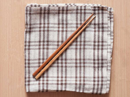 Wooden chopsticks on table cloth.の写真素材