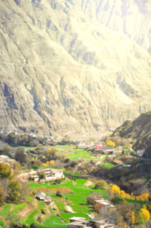 Blur background image of Mountains, town and rice field.