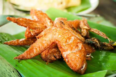 Fried chicken wings with thai herbsの写真素材
