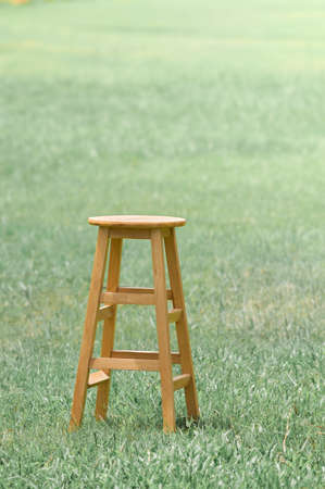 Wood chair in field with green grassの写真素材