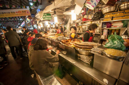 SEOUL, SOUTH KOREA - FEBRUARY 28, 2015 : People enjoying street food at Gwangjang Market.The market was established in 1905 .It has many restaurants and food stalls selling traditional Korean cuisine.のeditorial素材