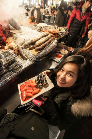 SEOUL, SOUTH KOREA - FEBRUARY 28, 2015 : People enjoying street food at Gwangjang Market.The market was established in 1905 .It has many restaurants and food stalls selling traditional Korean cuisine.のeditorial素材