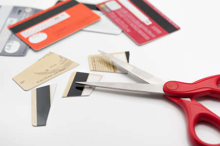Cuting credit cards with scissors.の写真素材