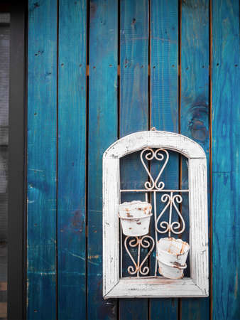 Empty flower pot abandoned on blue wood plank wallの写真素材