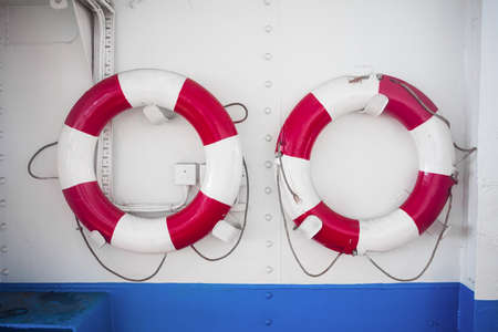 Life buoy on metal ship wall