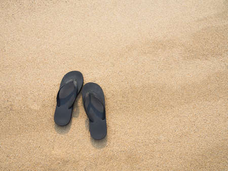 Flip flops on a sandy beachの写真素材