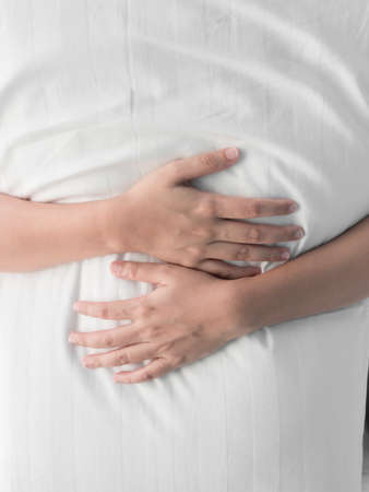 Woman hand hugging white pillowの写真素材