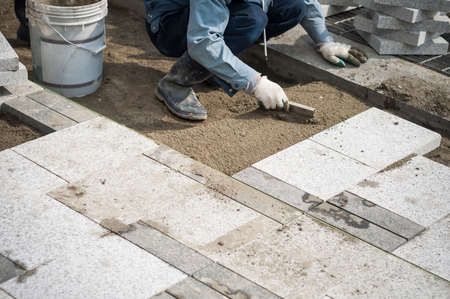 Construction worker installing the pavestone on the roadの写真素材