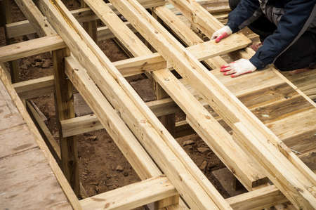 Carpenter working with wooden construction.の写真素材