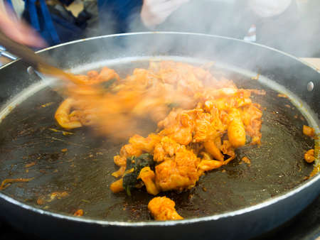 Dak galbi, traditional Korean food. Fried chicken with spice sauce and vegetable.