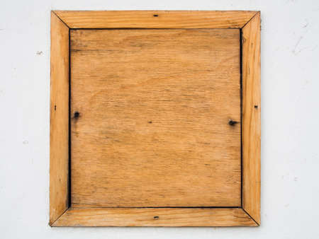 Brown old wood board on white cement wall backgroundの写真素材