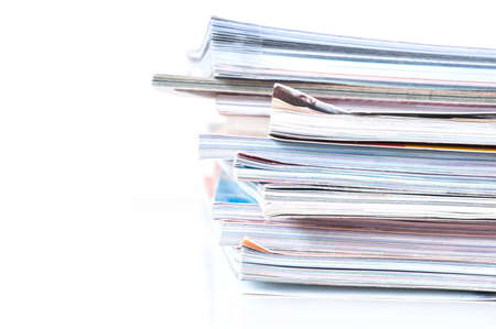 Pile of magazines on white background