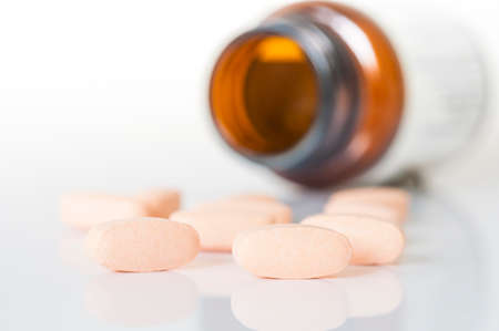 Pills and bottle on the white background.の写真素材