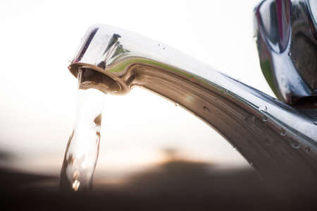 Open outdoor faucet wasted water.の写真素材