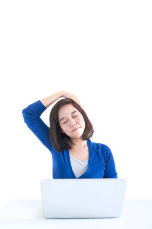 Business woman do stretch with laptop in front isolated over white background.の写真素材