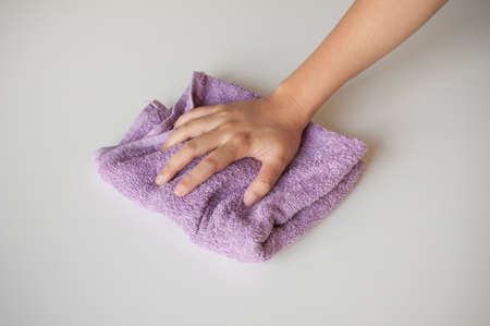 Hand and rag cloth cleaning on white backgroundの写真素材