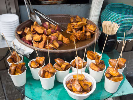 Sweet potatoes dessert in paper cup serve at street food market.の写真素材