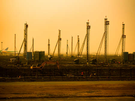 Construction site with yellow tractors and labors