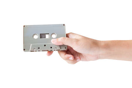 Hand holding cassette tape isolated on white background.の写真素材