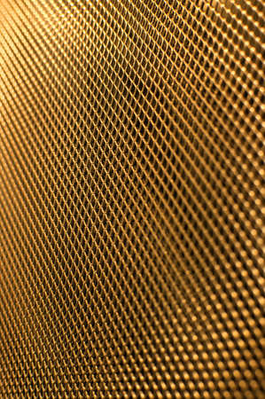 Perforated gold metal grate background.の写真素材
