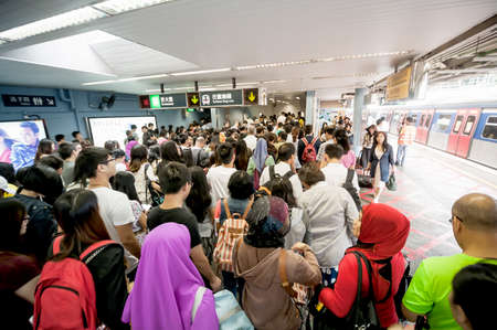 Hong Kong, China - October 4, 2015 : People waiting for delay MTR train while Typhoon Mujigae moving...